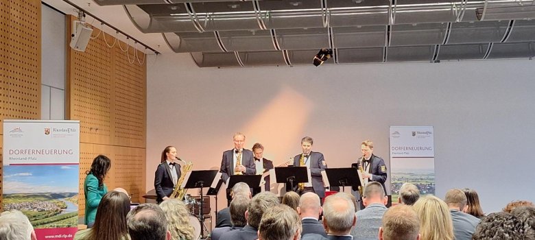 Musikerinnen und Musiker bei einer musikalischen Darbietung im Rahmen der Veranstaltung zur Auszeichnung der Ortsgemeinde Auw bei Prüm als Schwerpunktgemeinde